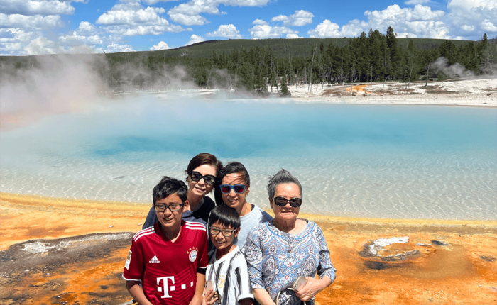 Mulit-generation family poses in front of Sunset Lake, Yellowstone National Park, taken on a Teton Excursions tour to Yellowstone National Park
