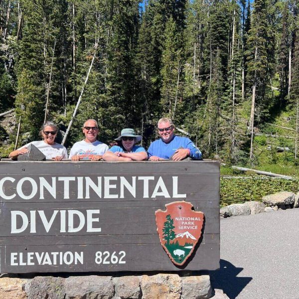 Guests at the Continental Divide sign during a private Yellowstone tour.