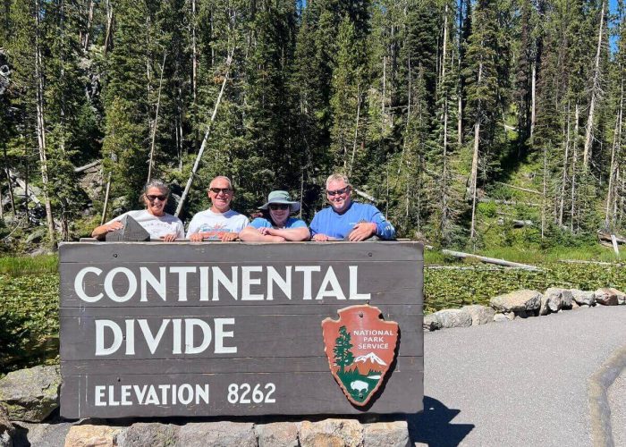 Guests at the Continental Divide sign during a private Yellowstone tour.