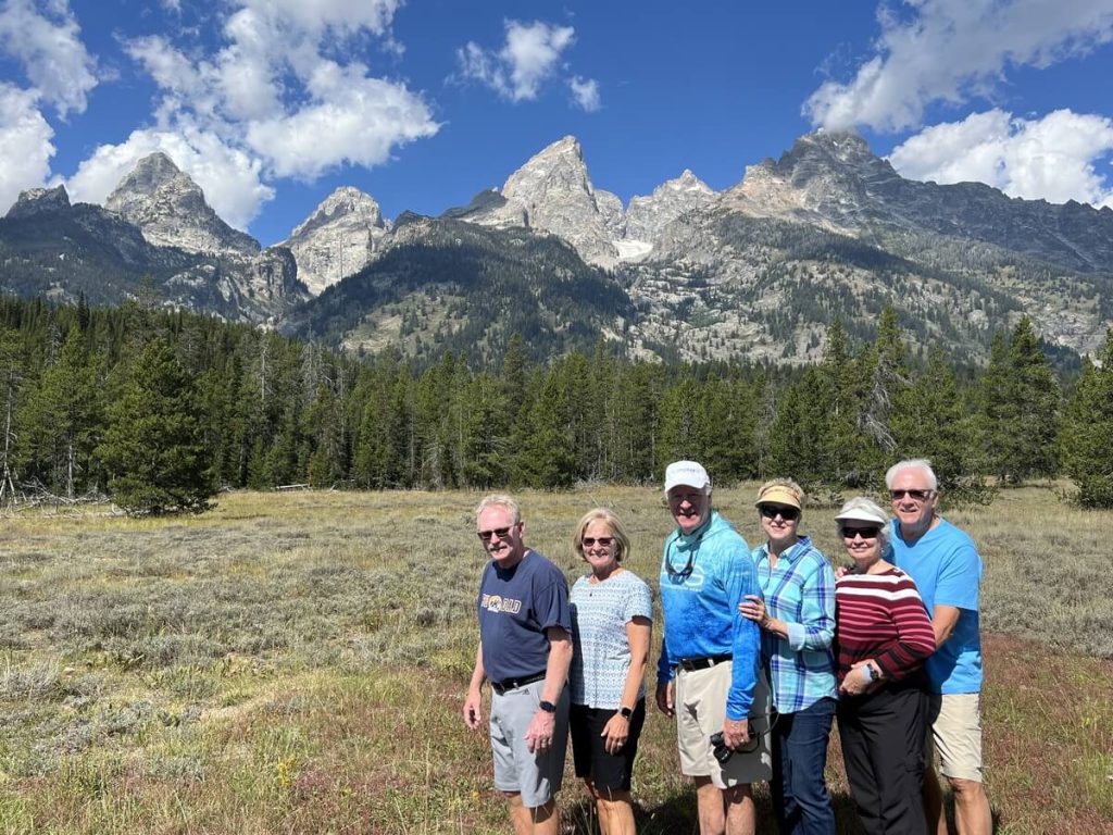 Senior guests enjoying a private Yellowstone tour with Teton Excursions in front of the Teton Range